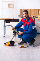 Fototapeta na wymiar Young male contractor working in workshop