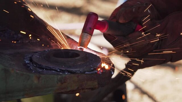 Cutting a circular Piece of Metal with a Cutting Blow Torch - Slowmo