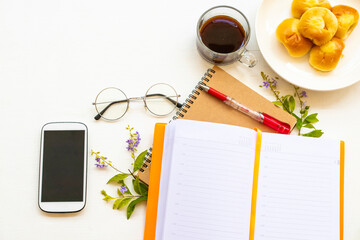 notebook diary ,mobile phone for business work with dessert ,hot coffee espresso of lifestyle arrangement flat lay style on background wooden white