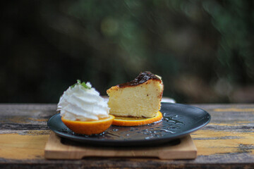 Basque cheesecake Burnt and delicious cheesecake with orange and whipped cream