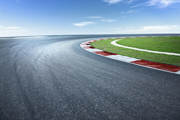 Asphalt race track with dramatic turning curve corner. - obrazy, fototapety, plakaty