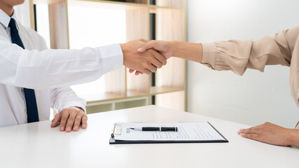 Two confident business man shaking hands during a meeting in the office, success, dealing, greeting and partner concept