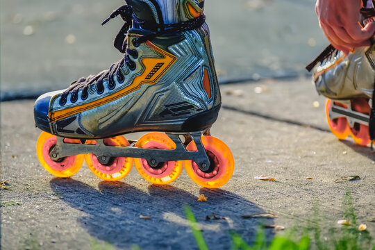 Inline roller blade skates with glowing orange wheels