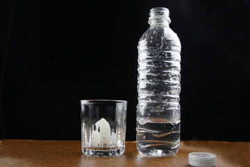 Bote de agua con vaso de vidrio