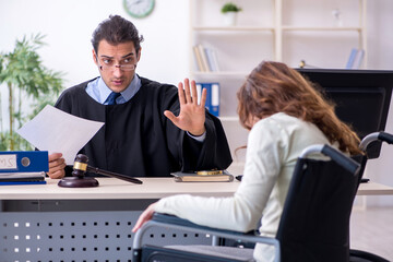 Injured woman and male judge in the courtroom