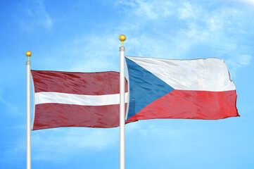 Latvia and Czech Republic two flags on flagpoles and blue sky