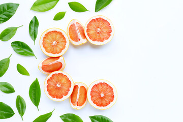 High vitamin C. Juicy grapefruit with green leaves on white