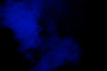 Blue color dust particles explosion cloud on black background.Color powder splash.