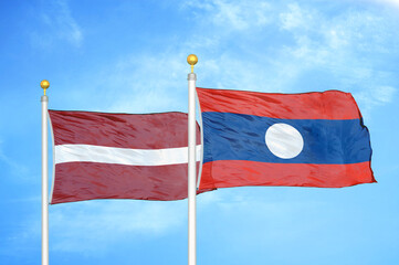 Latvia and Laos two flags on flagpoles and blue sky