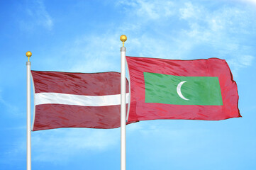 Fototapeta na wymiar Latvia and Maldives two flags on flagpoles and blue sky