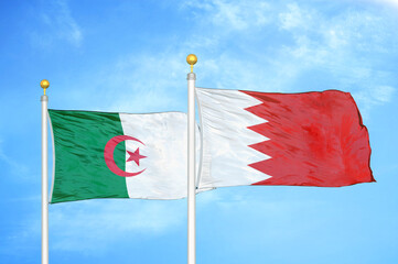 Algeria and Bahrain two flags on flagpoles and blue sky
