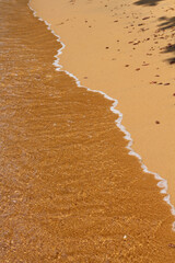 warm sand with small wave
