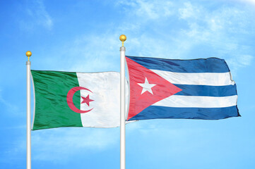 Algeria and Cuba two flags on flagpoles and blue sky