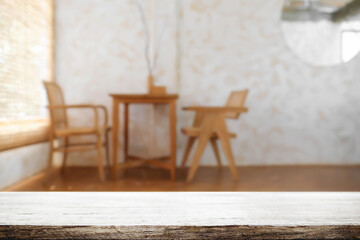 Empty wooden desk space and blurry background of coffee shop or Restaurant for product display montage.