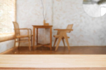 Empty wooden desk space and blurry background of coffee shop or Restaurant for product display montage.