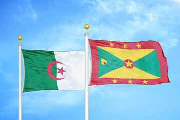 Algeria and Grenada two flags on flagpoles and blue sky
