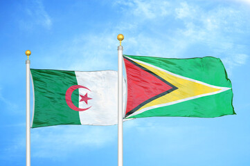 Algeria and Guyana two flags on flagpoles and blue sky