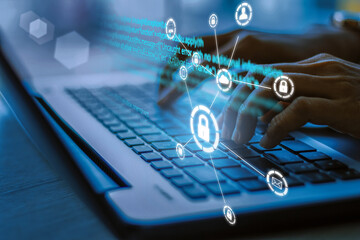 Business, technology, internet and networking concept. Young businesswoman working on his laptop in the office, select the icon security on the virtual display.