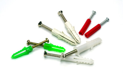 Different color wall plugs on white background.