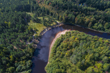 Fototapeta na wymiar Bend of the Mezha River from a bird's-eye view on a sunny September day (aerial photography). Kostroma region, Russia