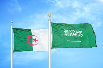 Algeria and Saudi Arabia two flags on flagpoles and blue sky