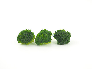 Broccoli steamed cut into pieces isolated on a white background. Helps with weight loss, reduces cholesterol and helps fight cancer..