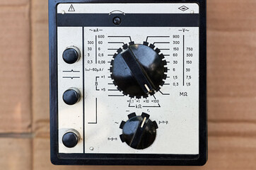 an old vintage multimeter with a brown screen and a metal plate with numbers
