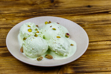 Pistachio ice cream on wooden table