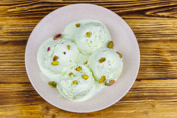 Pistachio ice cream on wooden table. Top view