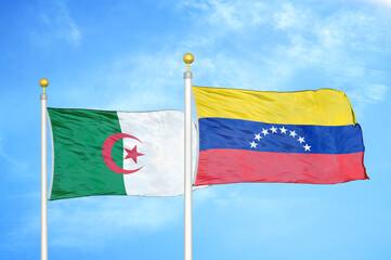 Algeria and Venezuela two flags on flagpoles and blue sky