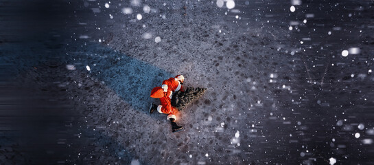 Fototapeta premium Santa Claus on ice skates goes to Christmas. Santa Claus hurries to meet the New Year with gifts and Christmas tree.