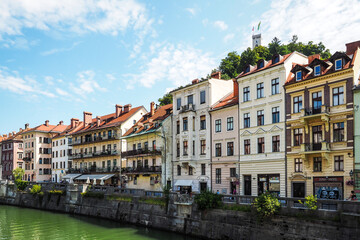 Naklejka na ściany i meble View on oldtown buildings, castle and Ljubljanica river in Ljubljana, Slovenia. Defocused