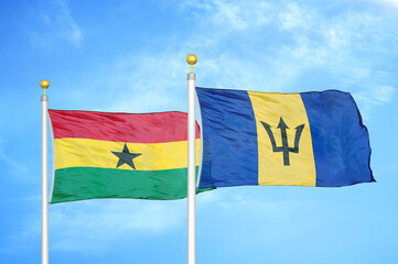 Ghana and Barbados two flags on flagpoles and blue sky