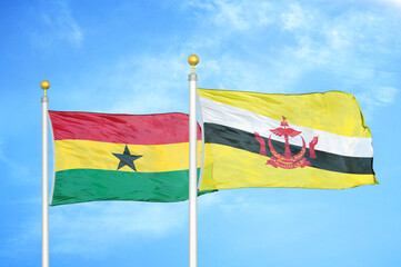 Ghana and Brunei two flags on flagpoles and blue sky
