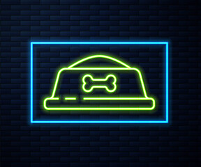 Glowing neon line Pet food bowl for cat or dog icon isolated on brick wall background. Dog bone sign. Vector.