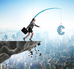 Businesswoman chasing money on fishing rod