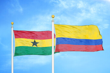 Ghana and Colombia two flags on flagpoles and blue sky
