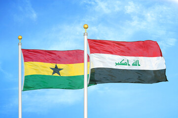 Ghana and Iraq two flags on flagpoles and blue sky