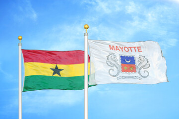 Ghana and Mayotte two flags on flagpoles and blue sky