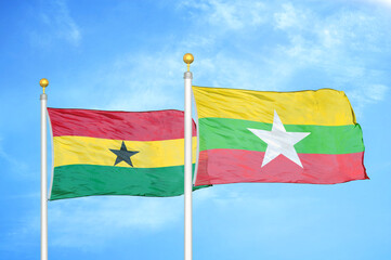 Ghana and Myanmar two flags on flagpoles and blue sky
