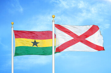 Ghana and Northern Ireland two flags on flagpoles and blue sky