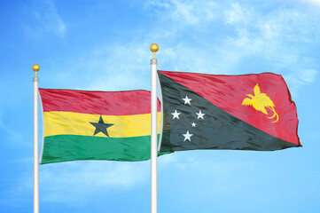 Ghana and Papua New Guinea two flags on flagpoles and blue sky