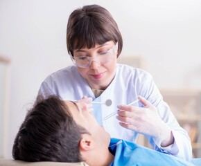 Obraz na płótnie Canvas Patient visiting dentist for regular check-up and filling