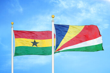 Ghana and Seychelles two flags on flagpoles and blue sky