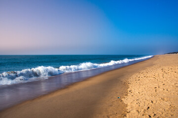 Fototapeta na wymiar Beautiful Goa Sea beach and water waves at the time of Sunset.