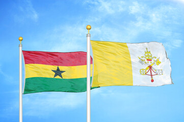 Ghana and Vatican two flags on flagpoles and blue sky