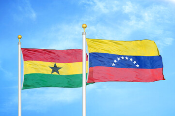 Ghana and Venezuela two flags on flagpoles and blue sky