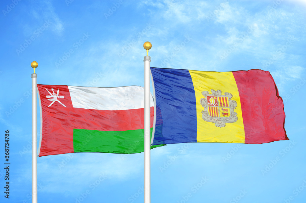 Wall mural Oman and Andorra two flags on flagpoles and blue sky