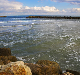 Fototapeta na wymiar Coastal rocks on quay Tel Aviv