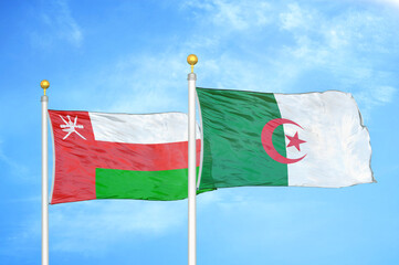 Oman and Algeria two flags on flagpoles and blue sky